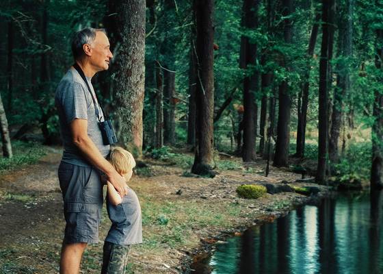 man and child in a forest