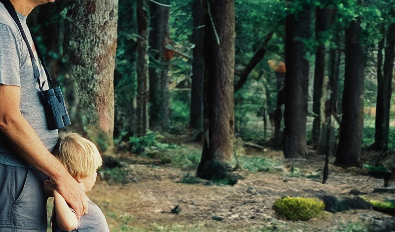 man and child in a forest