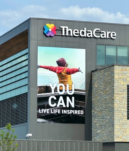 poster on the exterior of thedacare building