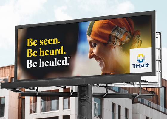 Billboard featuring female oncology patient in a support group with the words "Be seen. Be heard. Be healed." and the TriHealth Logo